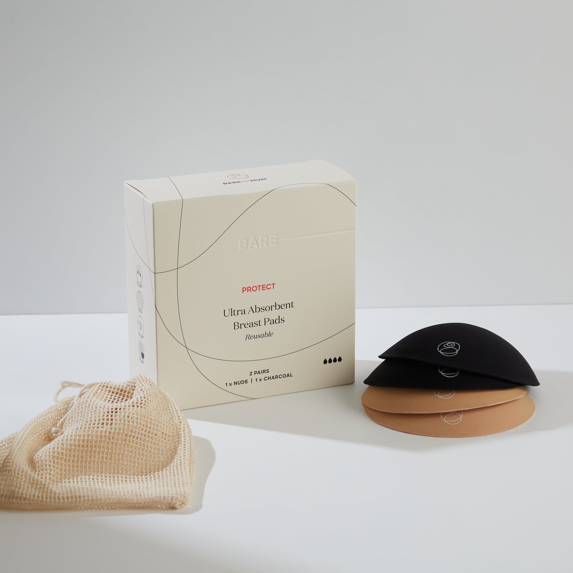 Bare Mum Ultra Absorbent Breast Pads box standing upright, breast pads stacked on top of each other next box, machine washable bag layer flat on other side of box