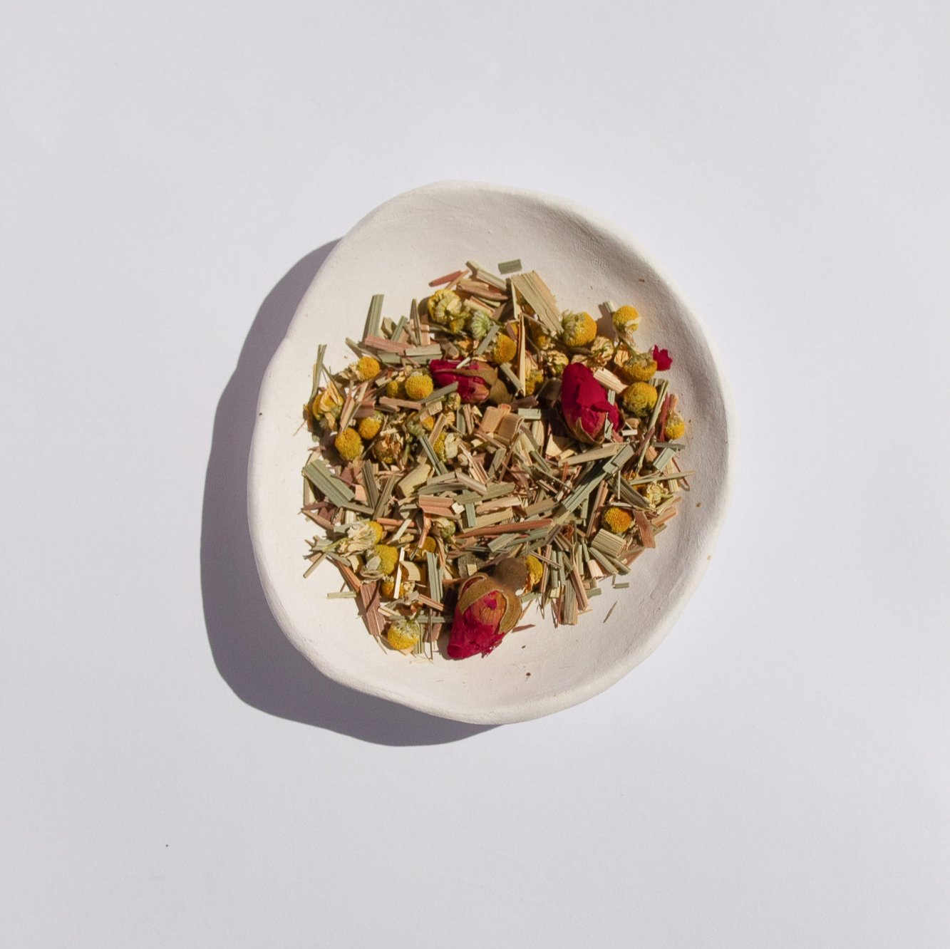 Nurtur tea calm blend loose leaf tea sitting in white bowl