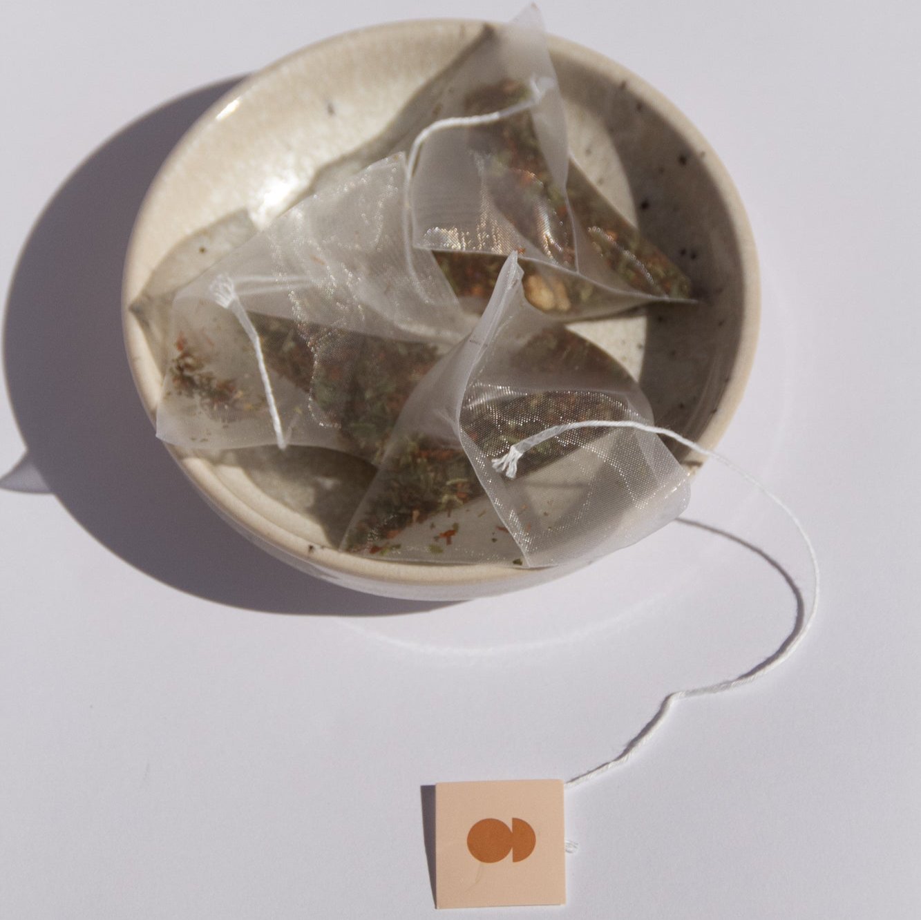 Nurtur Tea biodegradable tea bags sitting in ceramic bowl 